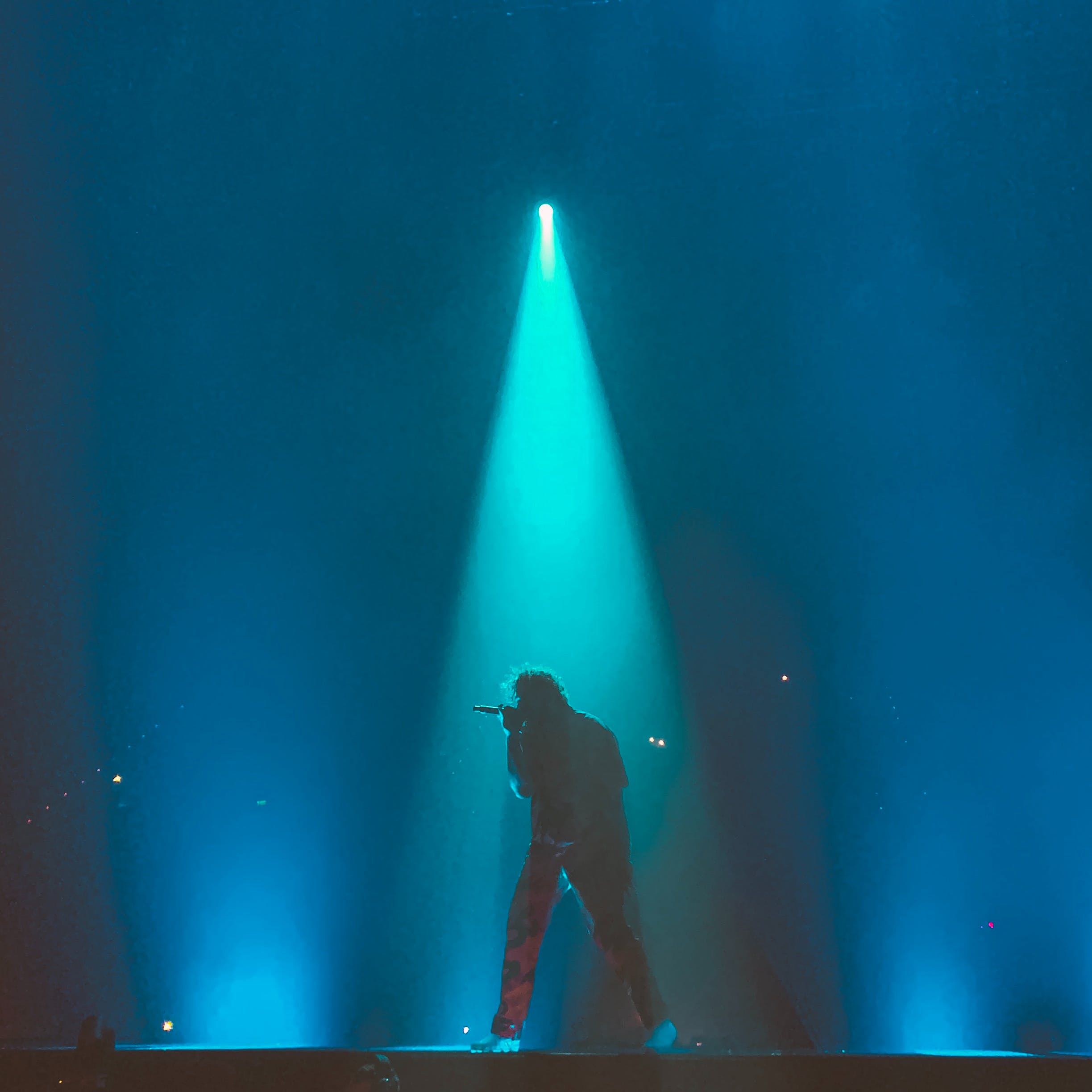 Person holding microphone on stage