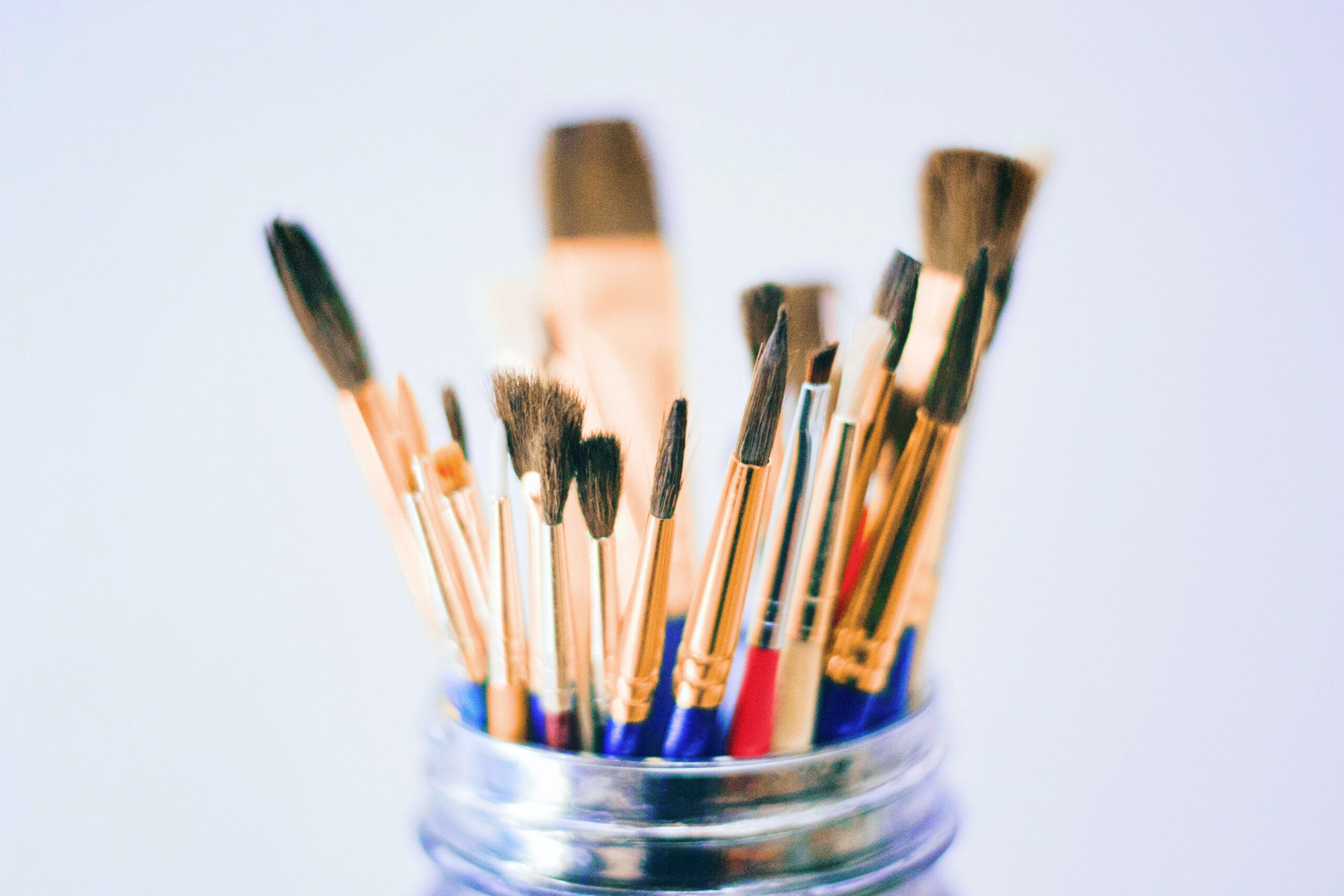 Shallow photography of brushes on jar