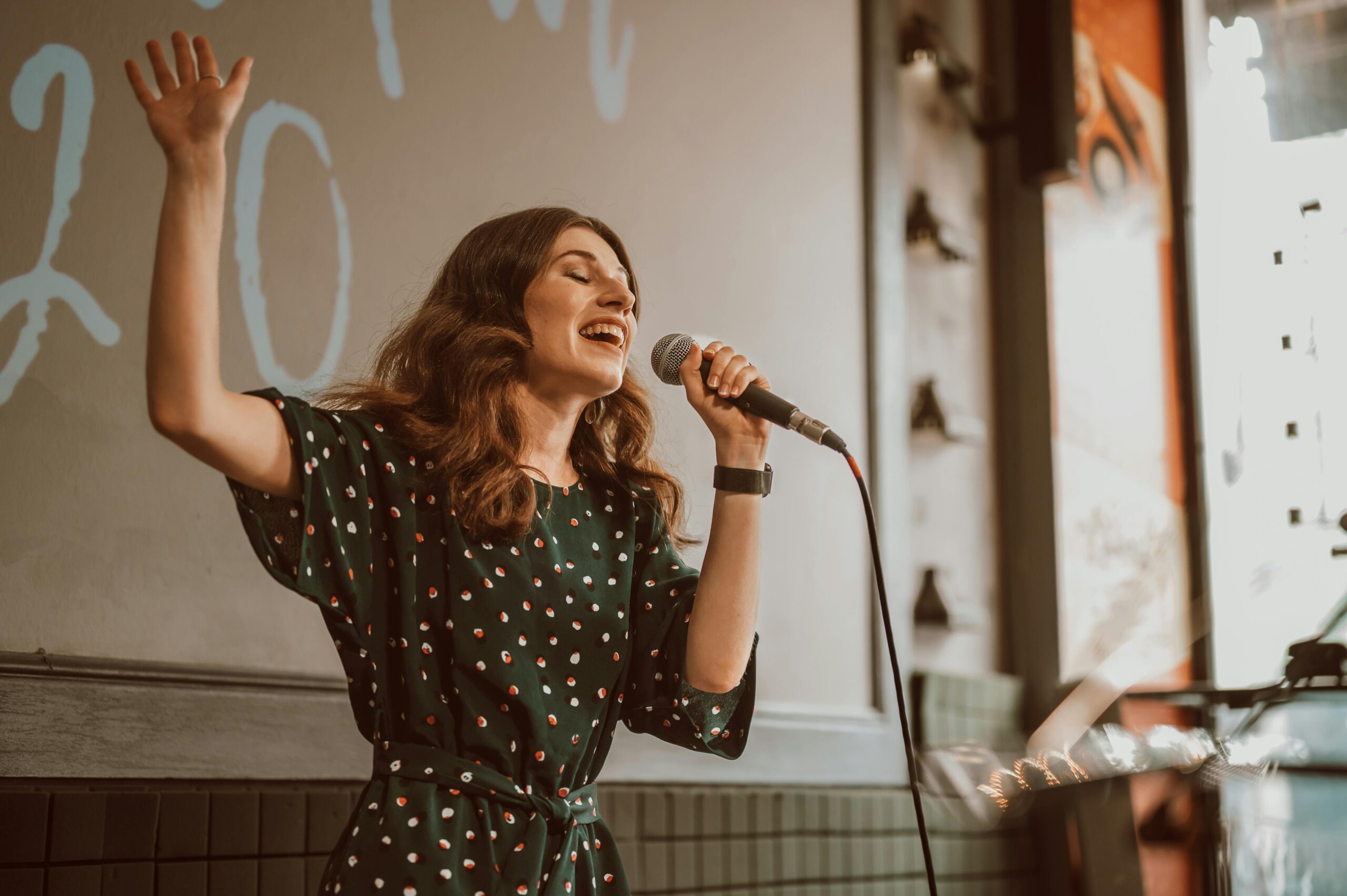 Woman in black dress singing gracefully