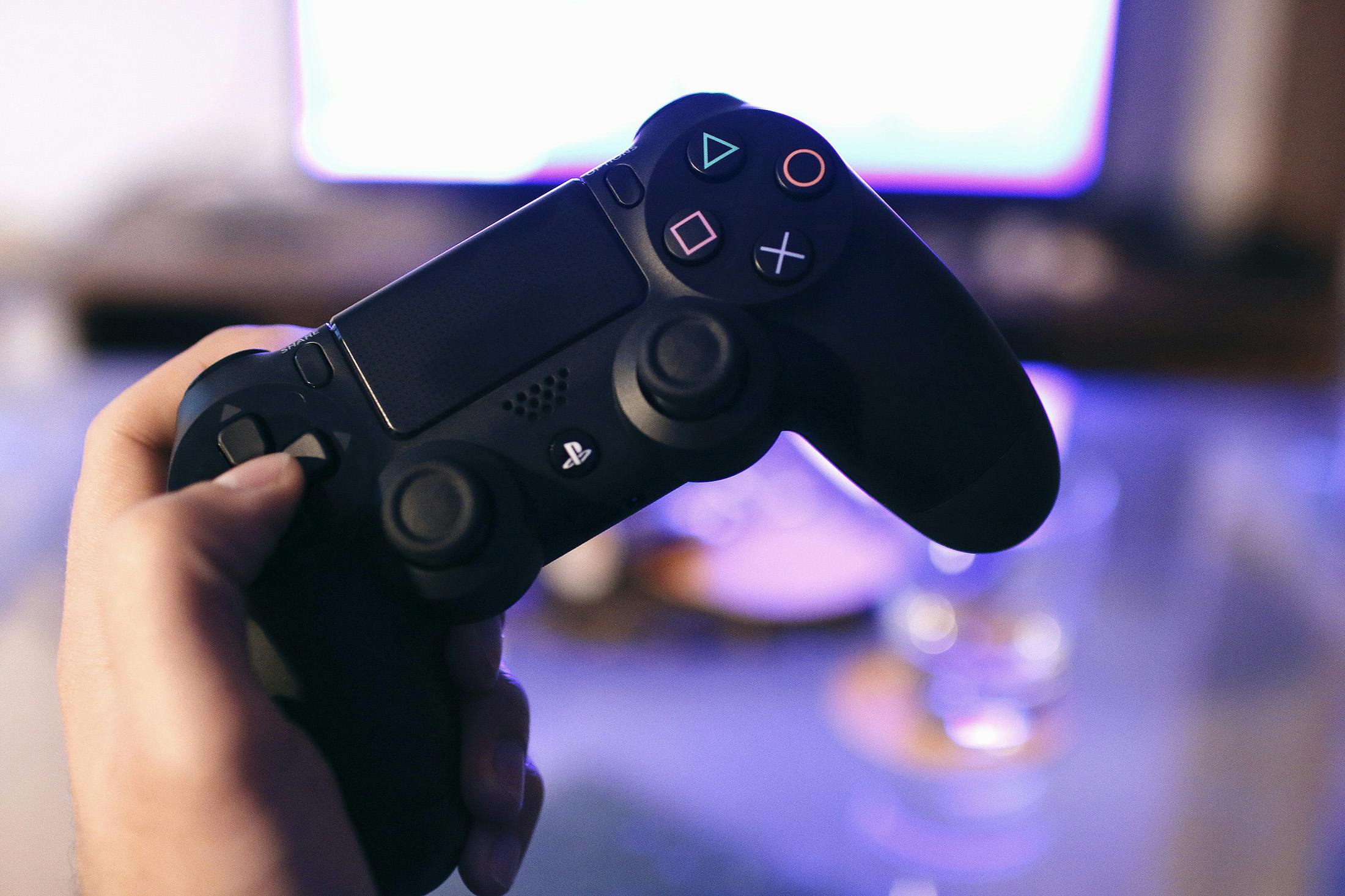 Person holding sony ps4 dualshock 4